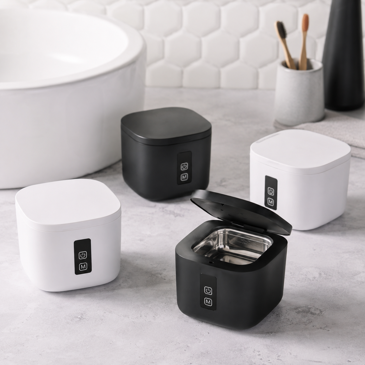 Four U-Brightwave ultrasonic cleaners in black and white arranged on a bathroom counter, one open showing the water basin.
